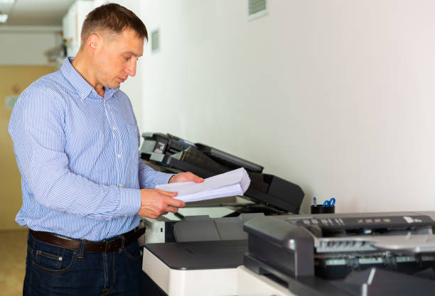 istock Businessman working with printer in the office 1221347498