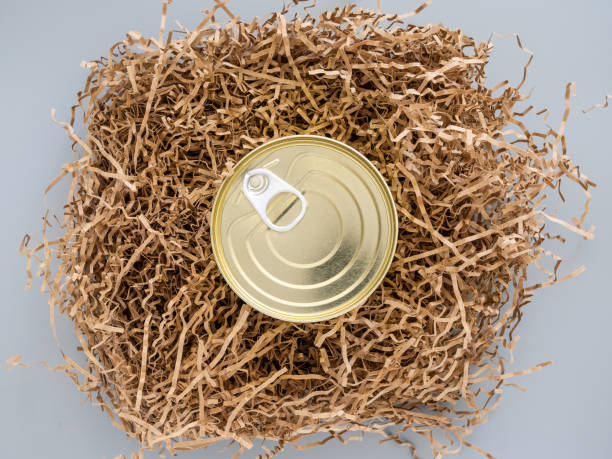 Tin can wrapped in paper, shockproof packaging, close-up, mock-up. Concept: a funny gift in quarantine. Careful delivery of food to the quarantine. Donating food items. Food help