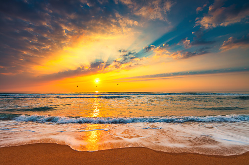 Beach sunrise over the tropical sea