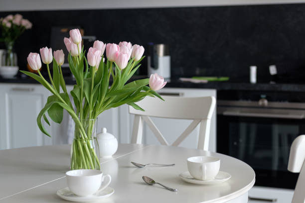 istock Bouquet of flowers in a vase on the kitchen table 1221348242