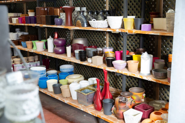 istock Rows with clay pots for plants in garden store 1221348385