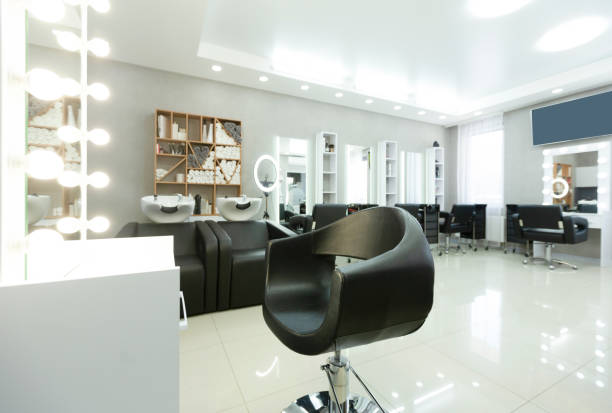 istock Barber chair and backlit mirror in bright Interior 1221349488