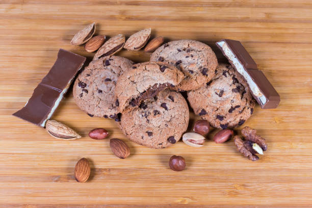istock Chocolate chip cookies among the chocolate pieces and various nuts 1221349508