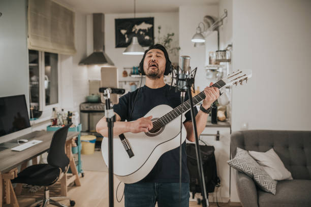 istock Japanese man doing a virtual band rehearsal 1221351557