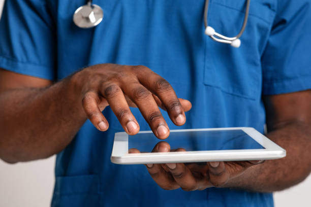 istock African american male doctor touching digital tablet screen 1221354432
