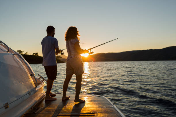 istock A Young Couple Fishing at Sunset, 1221355836