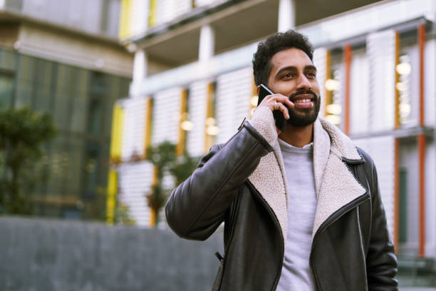 istock One young middle east man talking on the phone. 1221357671