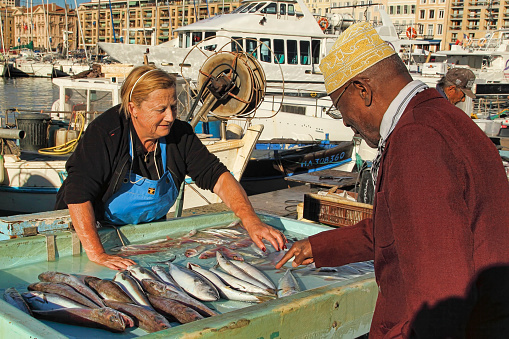 France, Marseille -November 19, 2015: The buyer at the fish market in Marseille.  Old Port of Marseille (Vieux-Port), Marseille is France's largest city on the Mediterranean coast and largest commercial port. October 19, 2015.