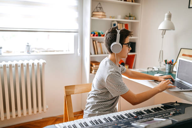 istock Teenage boy having online keyboard lesson 1221360714