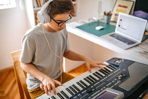istock Teenage boy having online keyboard lesson 1221360882