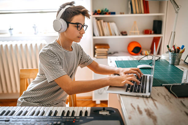 istock Teenage boy having online keyboard lesson 1221360977