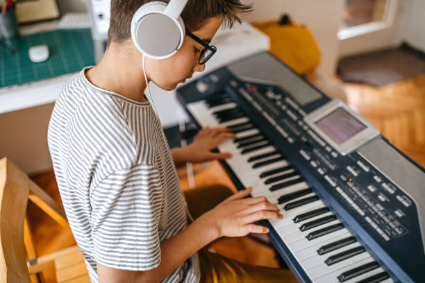 istock Teenage boy having online keyboard lesson 1221361119