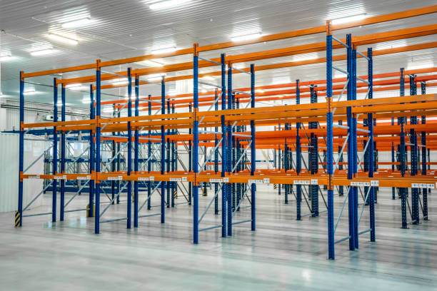 istock Orange warehouse shelves in grey interior. Orange storage warehouse. 1221362831