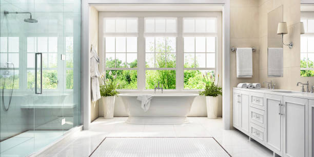 White bathroom with bath and large window Large white bathroom with bath, large window, shower and two washbasins bathroom stock pictures, royalty-free photos & images