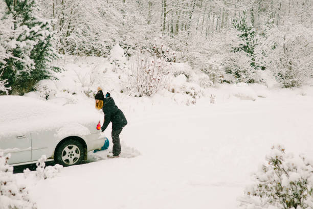istock Young Woman Clearing from Driveway in Canada 1221363072