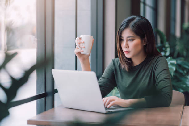 istock Beautiful Asian Woman Using Laptop Computer Online Working from Home ,  E-Learning , Online Shopping , E-Commerce , Freelance Concept - Healthcare and Social Distancing Concept 1221364141