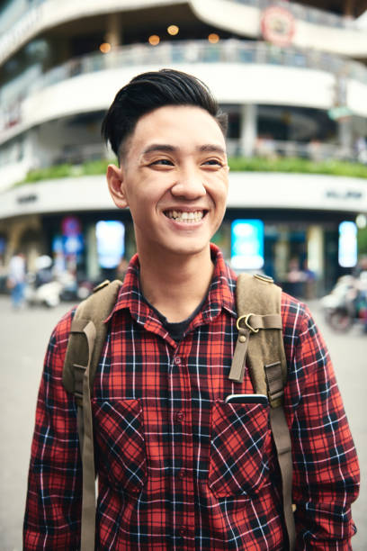 istock Young Asian man smiling and looking away 1221364625