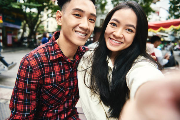 istock Young couple taking selfie while traveling 1221364649