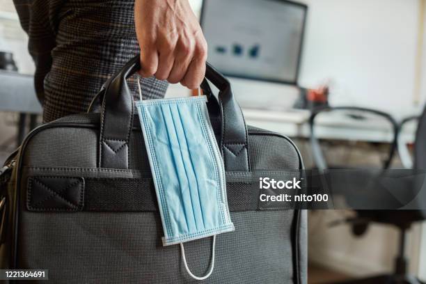 Man With A Briefcase And A Surgical Mask Stock Photo - Download Image Now - Coronavirus, Office, Occupation