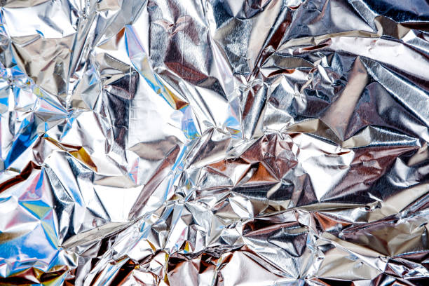 istock aluminium foil crumpled Silver texture abstract background 1221364769
