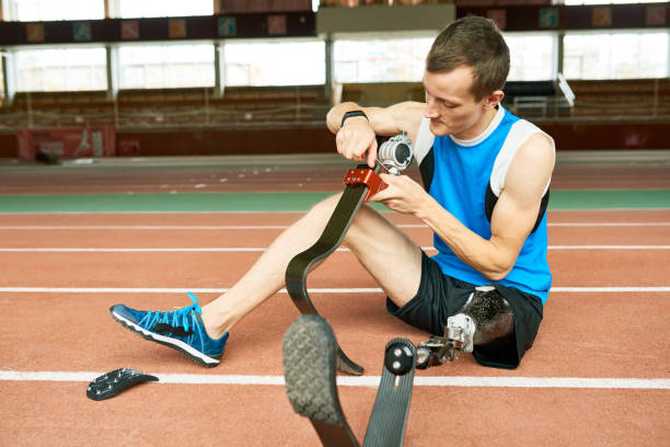 istock Handicapped Sportsman Fixing Prosthetic Foot 1221368688