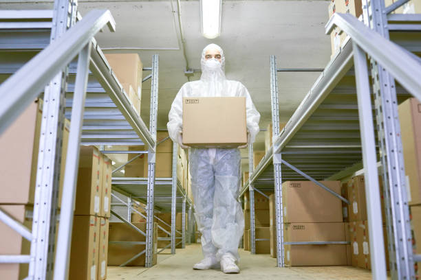 istock Young Worker Carrying Cardboard Box 1221368750
