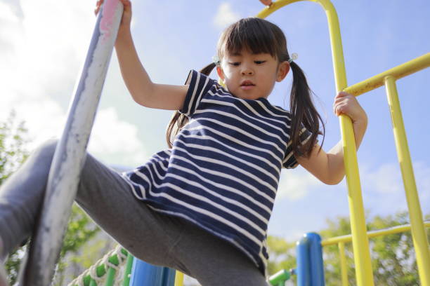istock Japanese girl playing with climbing pole (5 years old) 1221370286