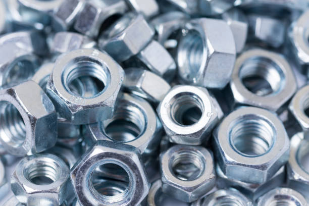 istock Pile of metal grey nuts in macro close up image 1221371784