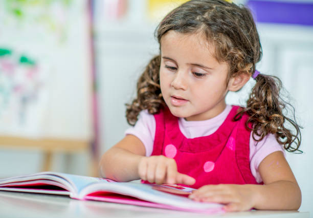 istock Cute little girl learning at home. 1221372664