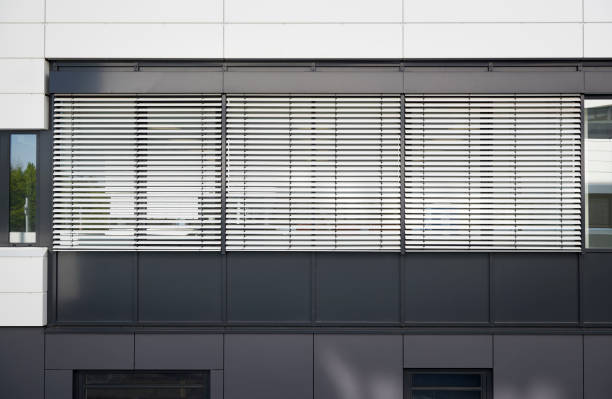istock Silver jalousies at three windows of an office building 1221373474