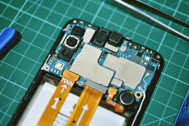 istock Phone repair, Fixing damaged mobile smartphone and hardware part changing, Close up of electronic circuit cell phone motherboard. 1221374241