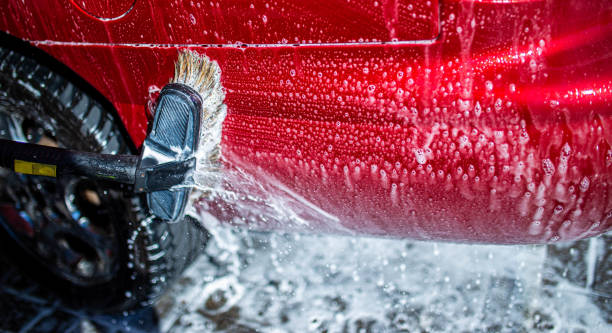 istock Hand washing with brush and compressor of a red car. 1221374387