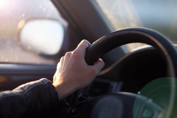 istock driving a car in summer, hand on the steering wheel. 1221375126