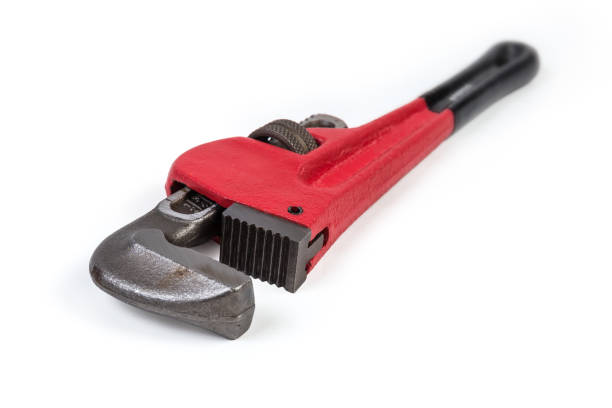 istock Modern pipe wrench on a white background, closeup in selective focus 1221376039