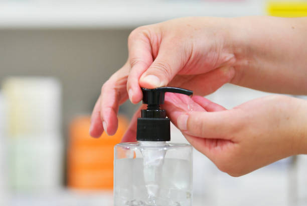 istock Pharmacist washing hand with Alcohol Sanitizer 1221376074