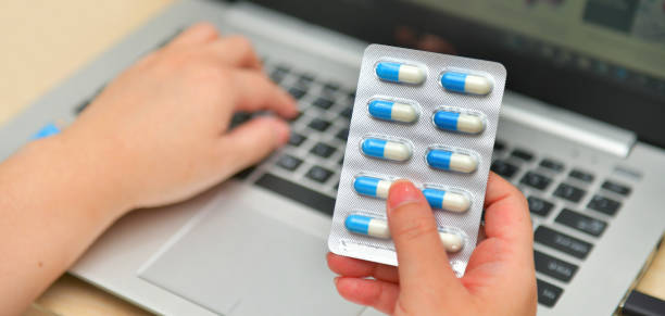 istock Pharmacist using the computer laptop in chemist shop or pharmacy drug store. 1221376807