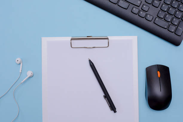 istock Workplace of freelancer, office worker. Keyboard, pen, clipboard on blue background. 1221377842
