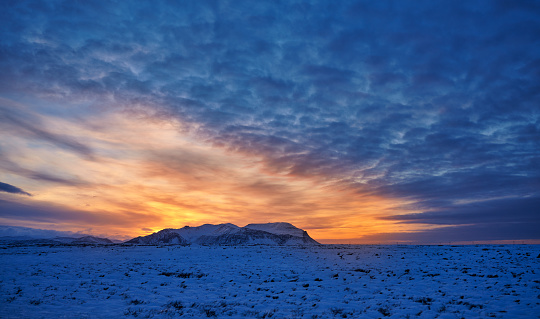 Horizontal shot of sunset in Iceland in the mountains, blue, yellow and orange colors