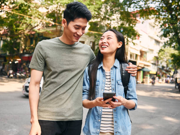 istock Young couple with smart phone in the city 1221380220