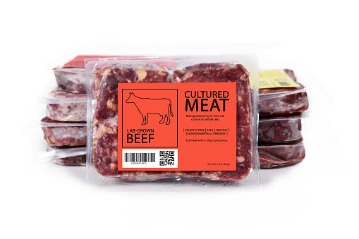Cultured meat concept for artificial in lab grown vitro cell culture beef meat production showing frozen packed raw  red meat with red label with text and cow on white background