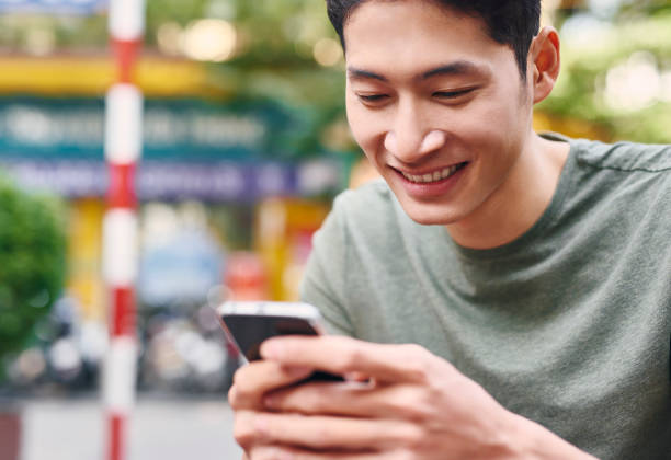 istock Smiling man with cell phone 1221381859