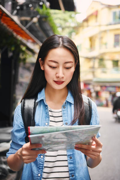 istock Happy tourist sightseeing city with map 1221381891