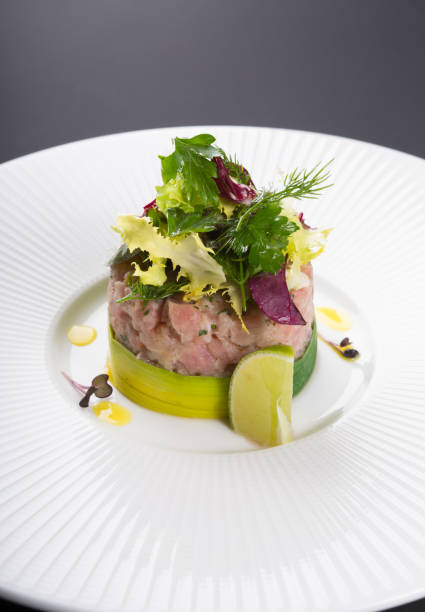 istock Freshly cooked tartare served with lime on white plate 1221385205