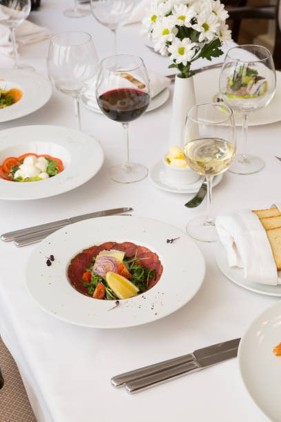 istock Prosiutto salad served with wine in a restaurant 1221385208