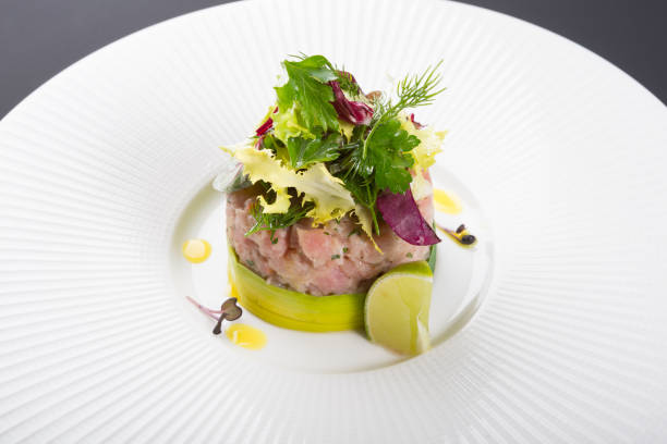 istock Freshly cooked tartare served with lime on white plate 1221385286