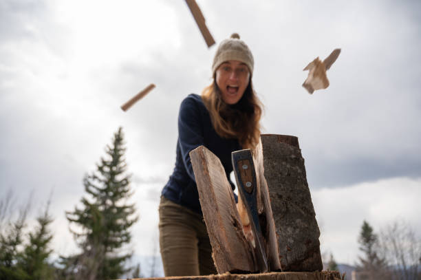 Senior woman chopping wood
