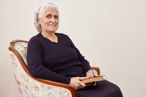 istock A delighted senior woman holding an enjoyable book in her hand while looking at camera with copy space 1221387001