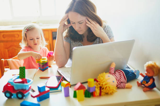 istock Exhausted and stressed mother working from home with toddler 1221387268