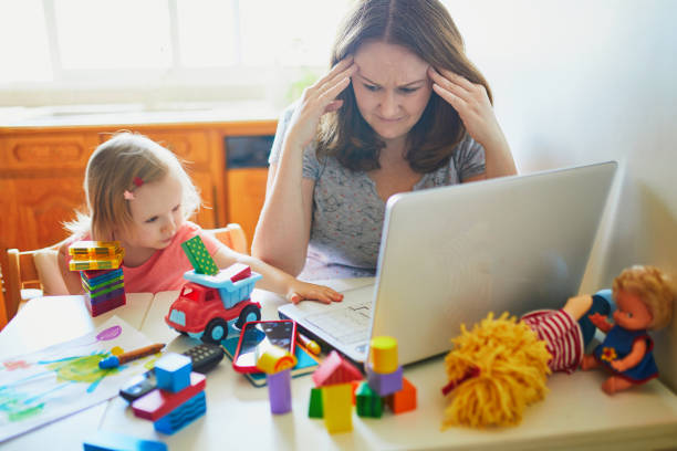 istock Exhausted and stressed mother working from home with toddler 1221387307