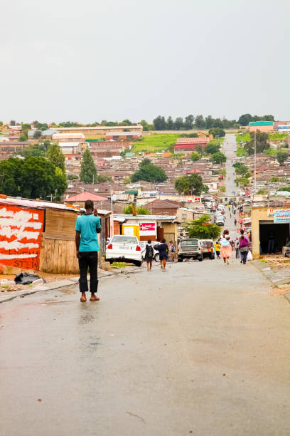African people walking down a main road in Alexandra township, a formal and informal settlement Johannesburg, South Africa - January 17, 2011: African people walking down a main road in Alexandra township, a formal and informal settlement alexandra township photos stock pictures, royalty-free photos & images